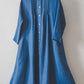 Blue color linen shirt dress hanging on a hanger