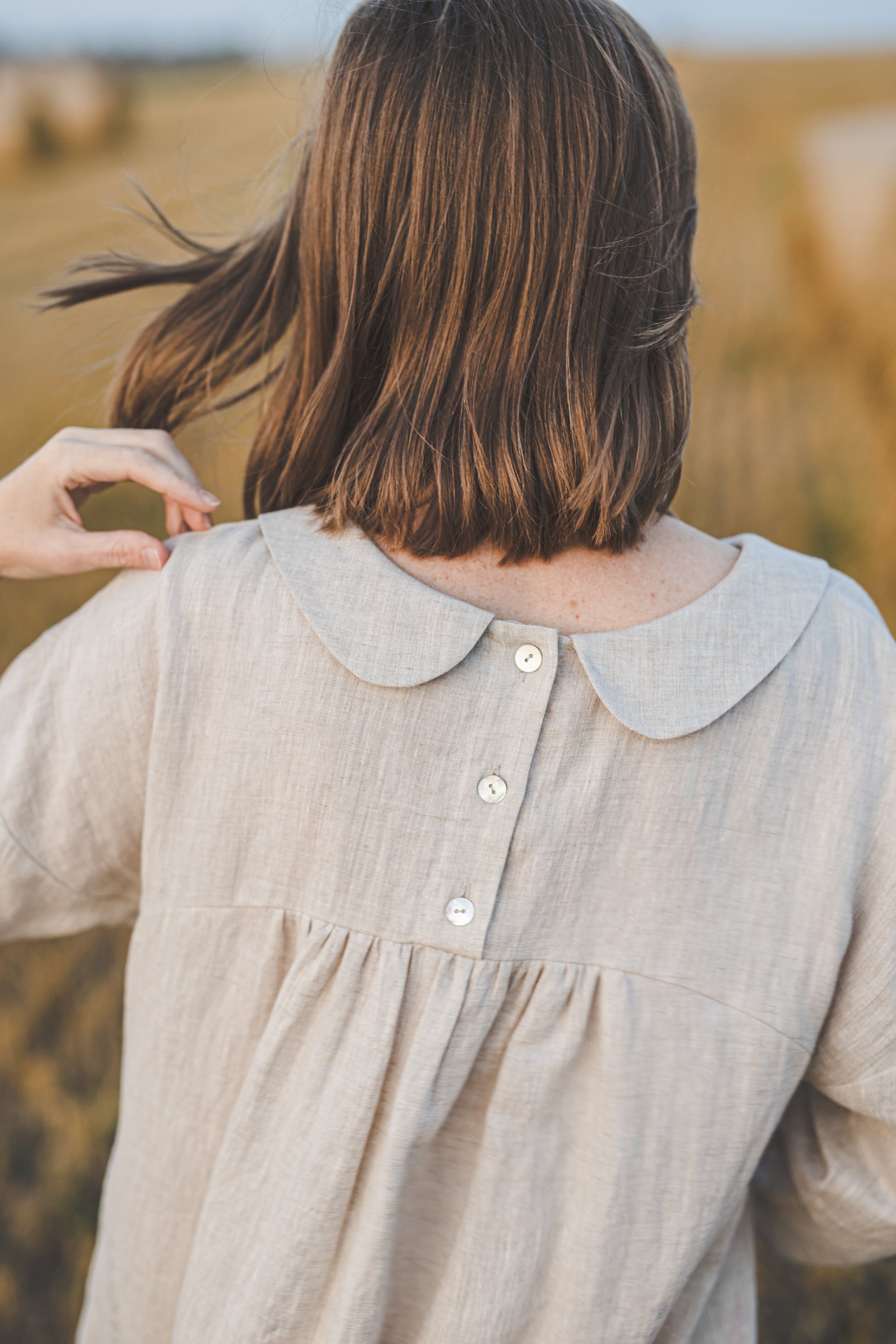 Round Peter Pan collars and natural shell buttons at the backside